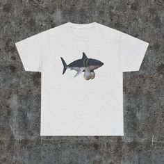 a white t - shirt with an image of a shark on it's chest