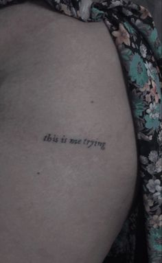 the back of a woman's thigh with a tattoo saying, this is not trying