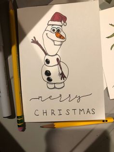 a drawing of a snowman wearing a santa hat and holding a pencil