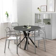 a dining table with four chairs around it