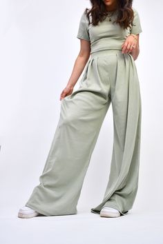 Look and feel your best in the Sage Ribbed Long Pant Set. This fashion-forward matching set features a ribbed texture and sage color making it the perfect choice for trendsetters. Crafted with comfort and stretch in mind, it features wide leg pants and a cropped top for an effortlessly stylish look. Specifications: ribbed elastic waist band x-long length pants trouser fit wide leg cropped top matching set sold together Olive Wide Leg Pants For Spring, Trendy Solid Color Wide Leg Loungewear Pants, Trendy Solid Color Wide Leg Pants For Loungewear, Trendy Solid Color Wide Leg Lounge Pants, Spring Solid Color Wide Leg Pants For Loungewear, Spring Wide Leg Pants For Loungewear, Solid Ribbed Pants For Spring, Green Wide Leg Full Length Pants For Loungewear, Ribbed Solid Pants For Spring