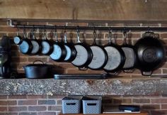 pots and pans are hanging on the wall