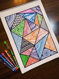 a drawing with colored pencils and markers on a table