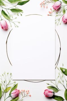 an empty card surrounded by pink flowers and greenery on a white background with place for text