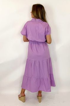 The Gayle Dress By Caryn Lawn is a stunning option for your spring and summer wardrobe! This poplin dress is a one size fits most (recommend for sizes 4-12), features a cross over v-neckline, loose flutter sleeves, an elastic waistline, and tiered midi length. Style this dress for a casual day with sandals or sneaker or dress it up for summer events by pairing with a pair of heels or wedges. Cotton Poplin FITS 4-12 BEST. FITS 5'4 AND TALLER BEST. Purple Solid Color Midi Dress For Summer, Summer Purple Solid Color Midi Dress, Summer Purple Solid Midi Dress, Purple V-neck Dress With Ruffle Hem, Purple Dresses For Spring, Purple Solid Color Dress For Spring, Lavender V-neck Maxi Dress For Spring, Purple Tiered Skirt Spring Dresses, Purple Tiered Skirt Dress For Spring