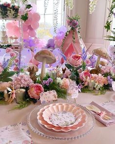 a table topped with lots of pink and purple decorations