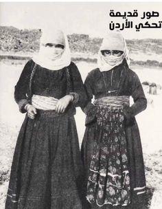 two women standing next to each other in the snow