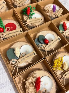 twelve christmas ornaments in boxes on a table