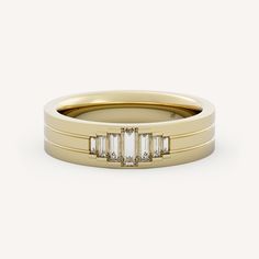 a yellow gold ring with three baguettes on the side and two diamonds in the middle