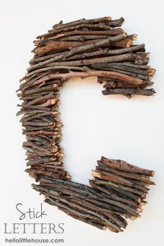 the letter c made out of sticks is shown on a white surface with text that reads stick letters