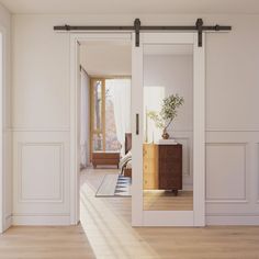 an empty room with white walls and sliding glass doors that open up to the bedroom