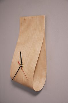 a clock made out of wood on the wall