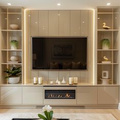 a living room with built in shelves and a flat screen tv