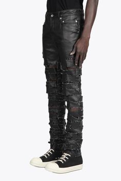 Rick Owens DRKSHDW Spartan Jeans Designer's ID: DU01B7360-SBKM With a snug skinny fit and low rise, these jeans hug all the right curves. The unique Spartan design is sure to turn heads, with horizontal raw cut straps interlocking with vertical straps running up the centre back and legs. Plus, the light-weight stretch denim has a black matte finish that's just irresistible. Color: Black Composition: 91% COTTON+6% ELASTOMULTIESTE, 3% RUBBER. Made In ITALY Urban Fitted Distressed Bottoms, Fitted Straight Leg Leather Pants For Streetwear, Urban Fitted Distressed Pants, Ripped Fitted Bottoms For Streetwear, Fitted Ripped Bottoms For Streetwear, Urban Fitted Leather Bottoms, Urban Style Fitted Leather Bottoms, Fitted Leather Urban Bottoms, Fitted Pants For Streetwear