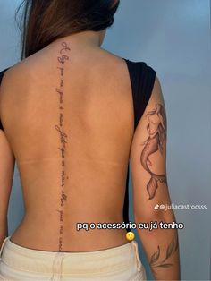 the back of a woman's body with tattoos on it