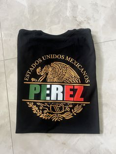 Show off your Mexican pride with this custom made Mexico shirt. May be personalized with a name of your choosing or a preferred state name.  If you need your item by a certain date please contact me so that we can work with you. If you have any problem with your order please feel free to contact us. T-Shirt:  Gildan Soft Style G6400 Solid Colors:4.5 oz/sq yd, 100% Ring Spun Cotton  Heathered Colors: 65% poly/35% cotton, Sport Grey 90%cotton/10%poly T-Shirt Care: Wash in cold cycle, inside out, n Fan Merchandise Tops With Custom Logo And Crew Neck, Fan Merchandise Crew Neck Tops With Custom Logo, Customizable Crew Neck Shirt For Fans, Mexican Names, Mexican Eagle, Mexican Pride, Mexico Shirt, Mexico Shirts, Eagle Shirts