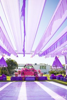 an outdoor area with purple and white decor