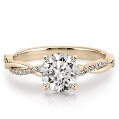 a rose gold engagement ring with a round cut diamond in the center and pave set shoulders