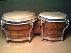 two wooden drums sitting next to each other