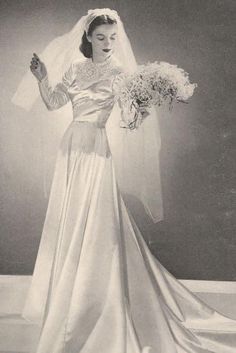 an old photo of a woman wearing a wedding dress and holding a bouquet of flowers