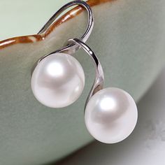 This delicate and understated style of earrings showcases a creamy white pearl bead attached to our signature silver IOBI Drill Hook. The classic and timeless look of pearls with a dash of silver. Customer verified as light and comfortable to wear all day every day! Gender: Female of any age Occasion: Special Occasions, Bridal, Birthdays, Perfect Holiday gift Materials: 14K White Gold plating over Alloy Size: 2cm long (.75 inch overall) Pearls: 10mm Resin pearl bead Comes gift boxed. Retail 49.95 Resin Pearl, Natural Pearl Earrings, White Pearl Earrings, Understated Style, White Pearl Earring, Freshwater Pearl Earrings, Freshwater Pearls Earrings, Modern Earrings, Pearl Drop