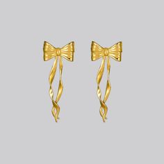 Make your heart flutter with our rendition of a pair of bow ribbon earrings. These earrings capture the luxury of style with the grace of a bow, a timelessly classic look with a modern twist. Also available in Silver. These earrings feature a base of sterling silver meticulously bonded with a generous layer of 24K gold (Gold Vermeil). Length: 41.5mm; Width: 15.3mm Designed in NYC Chic Formal Jewelry With Decorative Bow, Classic Bow Earrings For Anniversary, Elegant Butterfly Knot Earrings For Gift, Elegant Butterfly Knot Earrings As Gift, Classic Gold Bow Earrings, Elegant Gold Earrings With Bow Tie Detail, Chic Formal Jewelry With Ribbon, Chic Formal Bow Tie Jewelry, Classic Bow Earrings For Party