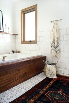 a bath room with a sink and a rug