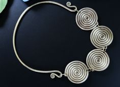 This unusual large Hmong torc-necklace was handcrafted during the mid-1900's for the Miao Hill Tribes of South Asia. It is a vintage tribal jewelry neck-ring - not a new reproduction. MEASUREMENTS: (1 inch = 2.54 cm): Neckline circumference = 20 inches Width across = 6.25 inches Weight = 8.7 oz (heavy) Shipping weight = 15 oz TM Image library = 3-9-2023 Torc neck-rings are a distinctive style of choker necklace that have been worn throughout Asia and the Indian subcontinent for centuries. This u Bohemian Ceremonial Necklace With Oxidized Finish, Tribe Necklace, Vintage Oxidized Brass Necklaces, Hmong Necklace Silver, Neck Rings, Tibetan Necklace Bohemian, Neck Ring, Neck Jewellery, Wire Jewelry Designs