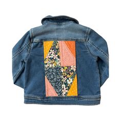 a denim jacket with patchwork on the back