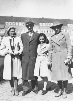 an old black and white photo of four people