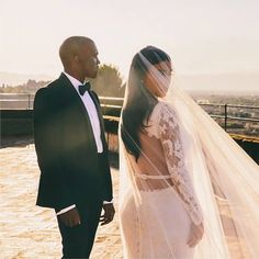 the bride and groom are looking at each other in front of an outdoor area that looks incredible