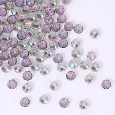 many different colored diamonds on a white surface