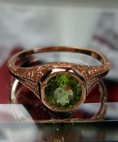 Natural Green Peridot Ring Dandelion Design#205 Custom This is a stunning Edwardian wedding reproduction gemstone filigree ring. The .85ct natural green peridot gemstone is 6mm in diameter. This lovely ring is 10K Rose Gold is marked 10K on the inner shank. Notice the beautiful craftsmanship of the rose gold filigree setting. This is an ornate and detailed ring. This is a lovely rendition of an Antique filigree wedding ring, and it is ready to wear. A ring gift box is included and all rings are Victorian Green Jewelry Stamped 14k, Antique May Birthstone Rings For Wedding, Antique May Birthstone Wedding Rings, Victorian 14k Stamped Green Jewelry, Green Engraved Wedding Rings, Wedding Jewelry Green Stamped 14k, Wedding Green Jewelry Stamped 14k, Antique May Birthstone Rings For Formal Occasions, Wedding 14k Stamped Green Jewelry