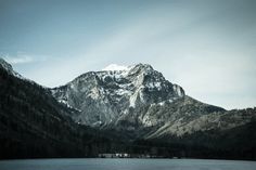 the mountains are covered in snow and trees