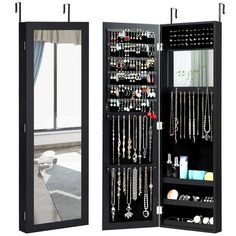 a black jewelry cabinet with mirrored doors and shelves filled with necklaces, bracelets, and earrings