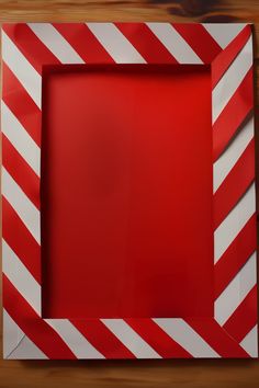 a red and white striped frame on a wooden table