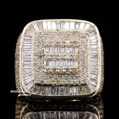 an 18k yellow gold ring set with baguettes and diamonds on black background