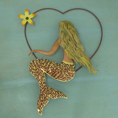 a painting of a mermaid holding a starfish in her hand and sitting on a heart