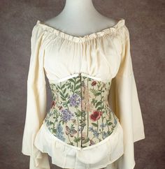 PRE-ORDER Ships early 2025 The lovely Lilly underbust corset in beautiful Ivory floral tapestry fabric.  My most flattering and comfortable underbust corset - easy to do up by yourself or with a helper.  This is a high quality handmade product. This lovely style gives a fantastic waist shape and suits most figure types.  The steel boned Lilly gives great waist compression and is made to last for years and years.  Combining a front busk and back lacing to make this steel boned corset easy to adju Fitted Overbust Corset Dress With Floral Print, Floral Print Overbust Corset With Fitted Bodice, Fitted White Corset With Floral Print, White Fitted Corset With Floral Print, Fitted Cream Corset With Boned Bodice, Beige Underbust Corset Belt, Cream Underbust Corset With Corset Back, Cream Underbust Corset With Fitted Bodice, Spring Beige Overbust Corset