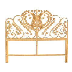 a gold metal headboard with decorative designs