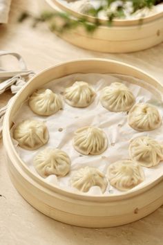 some dumplings are sitting in a bowl on a table