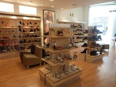 there are many pairs of shoes on display in the store