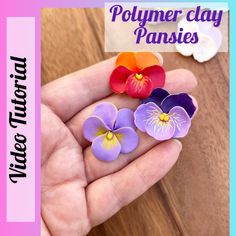 three polymer flowers in the palm of someone's hand with text overlay that reads polymer clay pansies