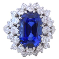 This is a beautiful and important Boucheron sapphire ring with a natural non-heated Royal Blue Burma sapphire of 7.70 carats (with SSEF certificate), surrounded by marquise cut diamonds of circa 4 carats. The sapphire is of gem quality and exhibits a very fine crystal with no visible inclusions. The ring is signed by Boucheron and has its makers' marks. Ring size 5-1/2. Boucheron Jewelry, Blue Sapphire Jewelry, Diamonds Rings, Vintage Cocktail Ring, Bracelets Design, Wire Necklace, Diamond Cocktail Rings, Sapphire Diamond Ring, Vintage Cocktail