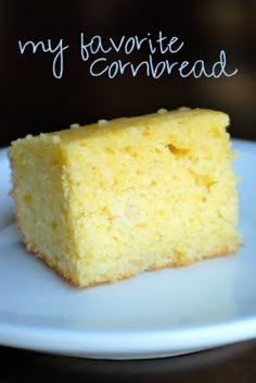 a piece of yellow cake sitting on top of a white plate with the words my favorite cornbread written above it