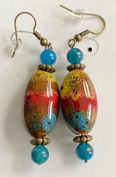 "Beautiful tie dyed painted clay, with Apatite accent beads, fish hook earrings with rubber backs Charm length-1.75\" Total length - 2.25\"" Multicolor Teardrop Casual Jewelry, Multicolor Hand Painted Earrings For Beach, Casual Multicolor Teardrop Jewelry, Adjustable Turquoise Earrings With Large Beads, Adjustable Multicolor Earrings With Large Beads, Fan Bracelet, Philadelphia Eagles Fans, Painted Clay, Ceramic Earrings