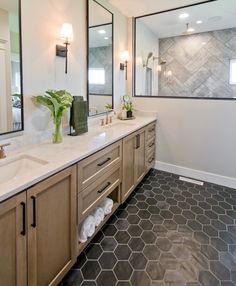 a large bathroom with two sinks and mirrors