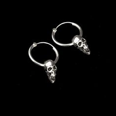 Sterling silver hoop earring has a diameter of 7/8 inch with a 5/8 inch silver plated pewter skull hanging from it. It latches by fitting the wire section back into the hollow hoop. The hoop is 7/8 inch x 2mm thick. The combined pieces measure 1.25 inches. These are sold per pair. This piece of jewelry is sent in a bubble pack envelope via US postal service, first class mail with insurance, free in the US. International rate is $15. Buyers are responsible for any customs and import taxes that ma Edgy Sterling Silver Jewelry For Halloween, Sterling Silver Skull Jewelry For Streetwear, Nickel Free Small Hoop Punk Jewelry, Nickel-free Small Hoop Punk Jewelry, Silver Skull Earrings With Ear Wire, Gothic Sterling Silver Jewelry With Skull Print, Edgy Silver Skull-shaped Jewelry, Edgy Silver Skull Jewelry, Edgy Silver Small Hoop Earrings