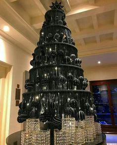 a very large christmas tree made out of wine glasses