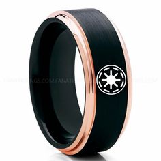 a black and rose gold ring with a star wars symbol on it